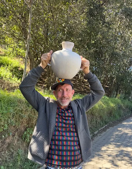 Lake Atitlan Rotarian Clint demonstrates the discomfort of carrying a 25 lb vessel for holding water on your head.